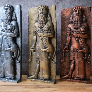 Gilgamesh Sculptures standing on a wooden table in front of an old plastered wall. Silver, gold and copper colors.