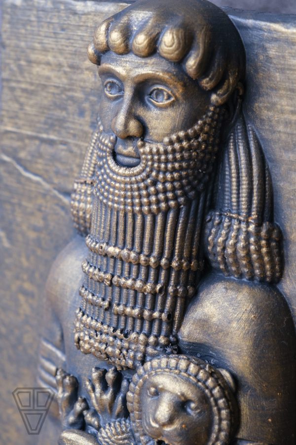 Close-up of the intricate carving on the Gilgamesh sculpture, showing fine details and craftsmanship