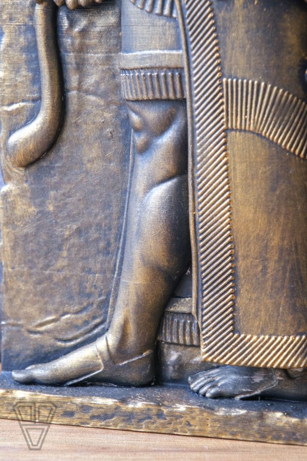 Close-up of the intricate carving on the Gilgamesh sculpture, showing fine details and craftsmanship